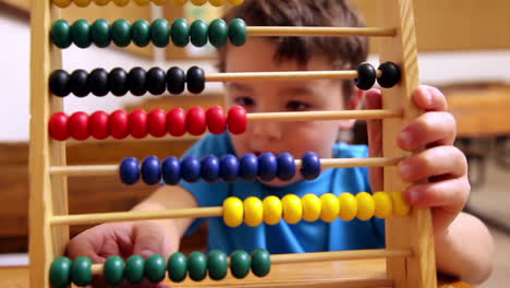 cute pupil using abacus