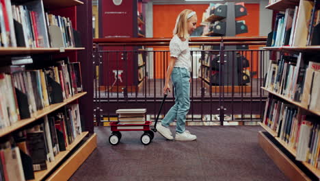 girl with wagon of books in library