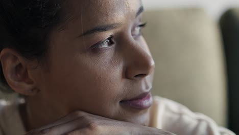 close up of smiling woman looking away and spending time at home.