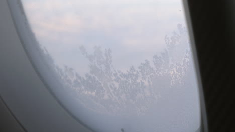 frozen glass of illuminator in flying airplane