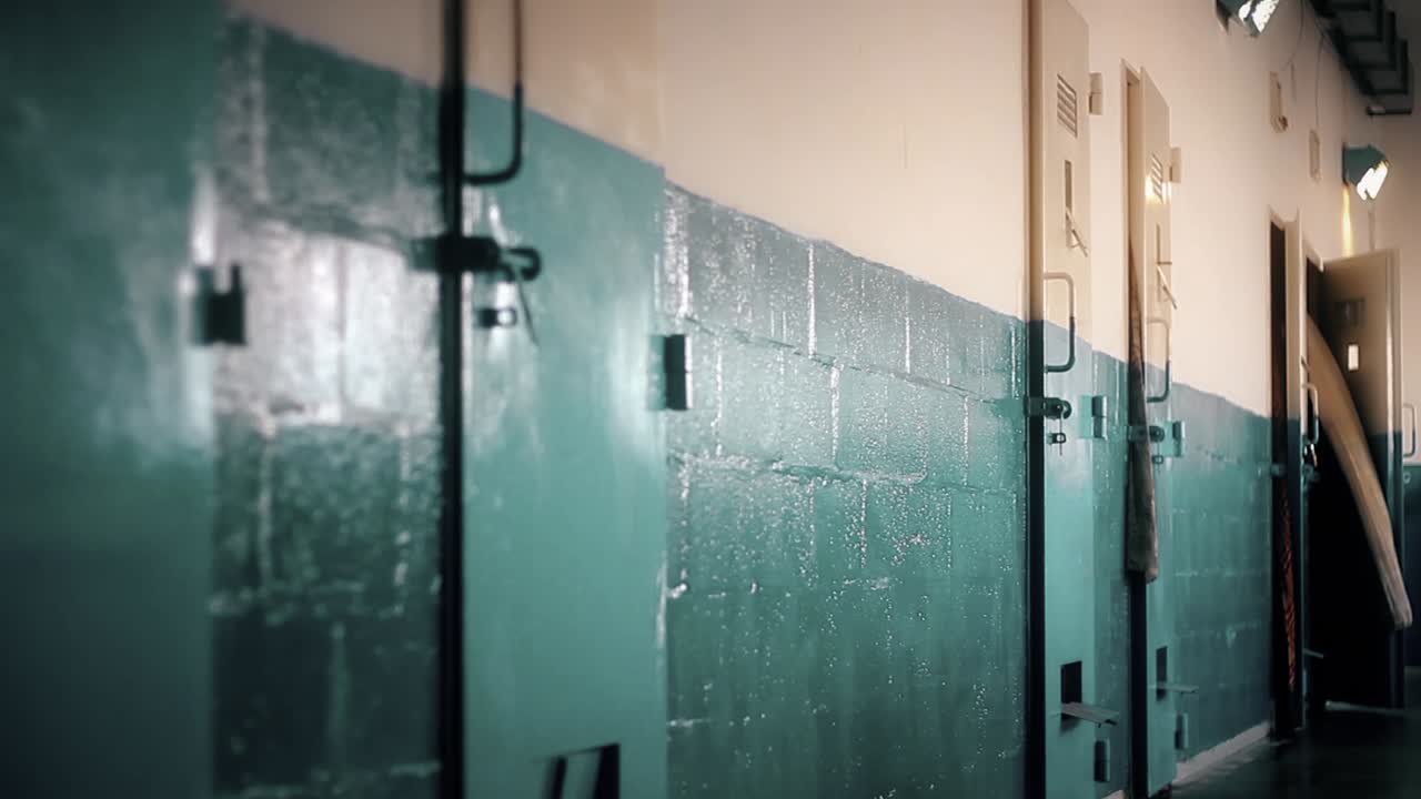 Long Hallway of an Old Jail with Cell Doors