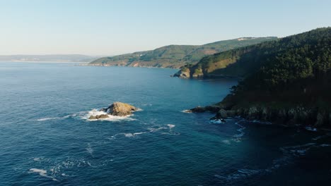 a picturesque view of the tranquil waters of malpica - aerial pullback