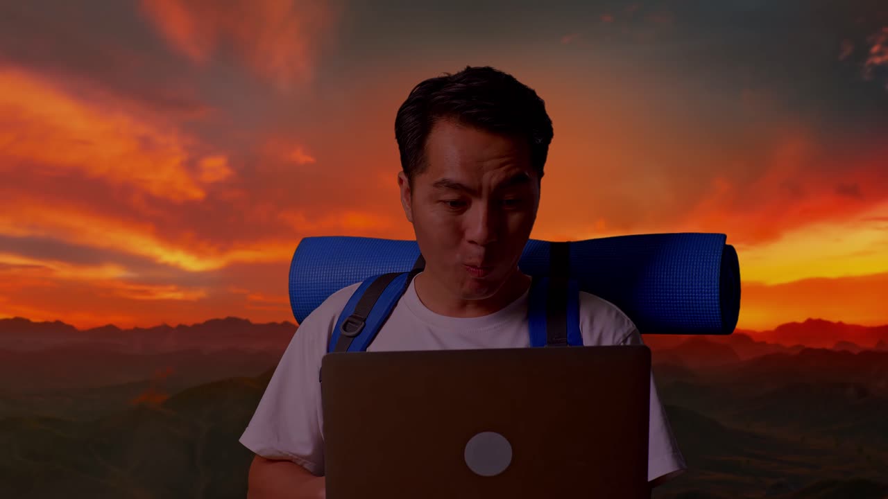 Man Working on Laptop at Sunset