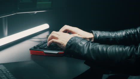 hacker typing on keyboard in dark room