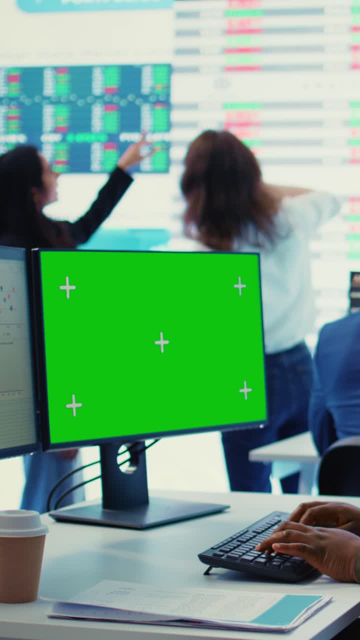 Green Screen Monitor on Office Desk with Person Typing