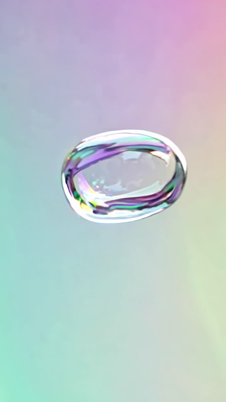 A close-up video of a single soap bubble floating against a pastel gradient background
