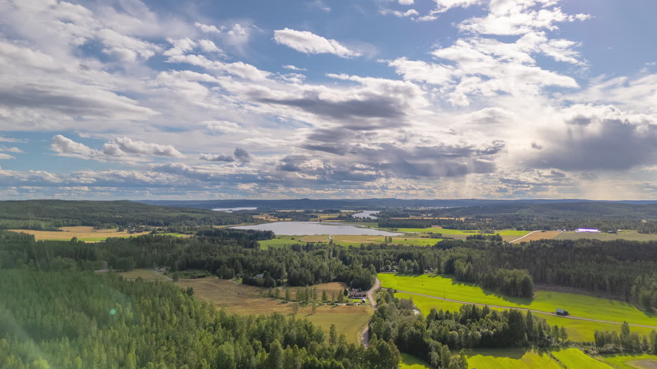 Aerial hyperlapse of clouds flying over rural forested landscape of Dalarna