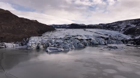silent frozen lake embraces glacier edge at sólheimajökull iceland
