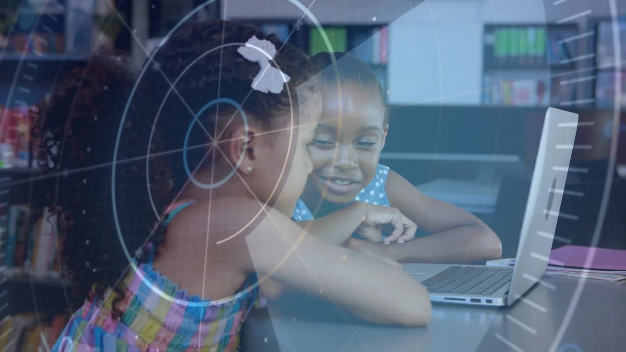 Two girls leaning over laptop in library, screen making HUD overlay pointing, smiling and learning