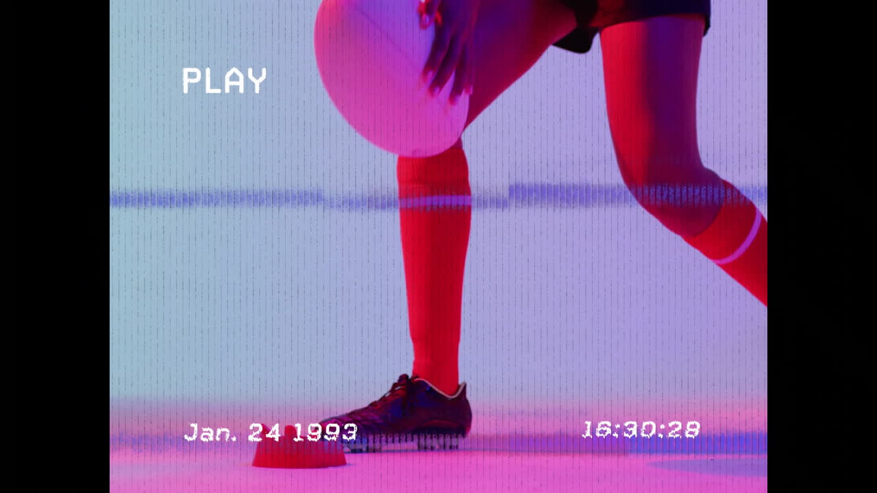 Holding rugby ball, person with animation overlay of retro timestamp and play text