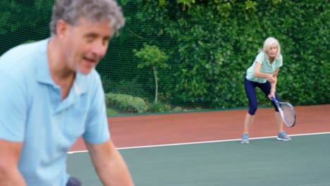 senior couple giving thumps up to each other while playing tennis 4k