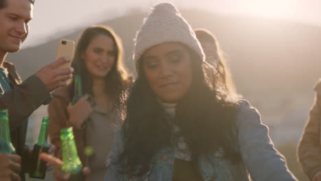 multi-ethnic-friends-dancing-celebrating-on-rooftop-at-sunset-enjoying-party-weekend-having-fun-socializing-hanging-out-drinking