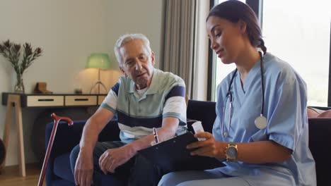 Animation-of-happy-biracial-female-doctor-talking-about-medicines-with-caucasian-senior-man