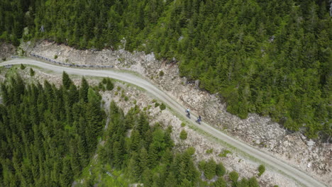 cyclist group cycling on road in mountains in moravia, drone shot