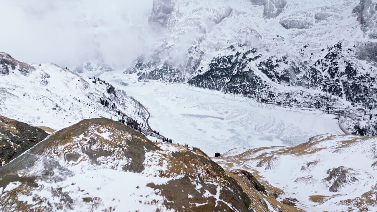 Aerial drone view of Portavescovo covered in snow, in Arabba, Italy