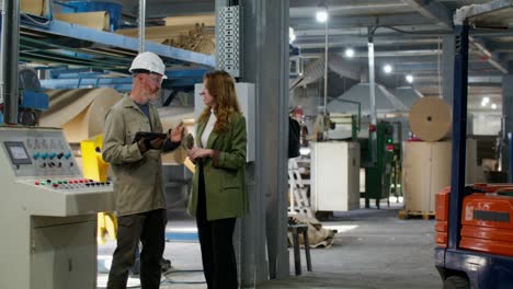 factory workers discussing operations