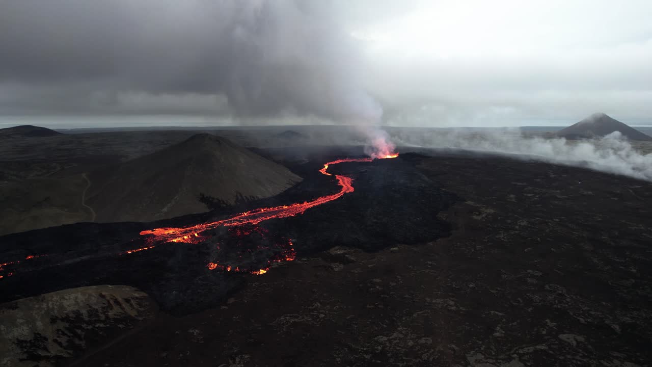 counter clockwise high angle drone shot of the litli hrutur volcano in iceland with fog and smoke