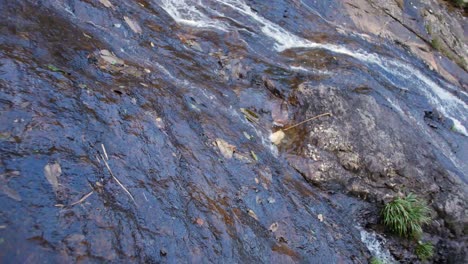 slow-gimbal-shot-following,-tracking-a-waterfall-stream-in-vietnam