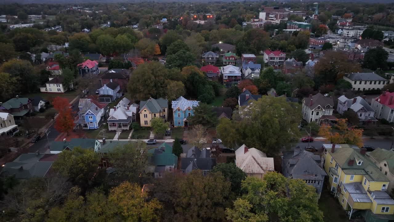 Colorful house in American neighborhood at dusk in autumn. Single family homes in suburb of Michigan.Aerial top down shot.