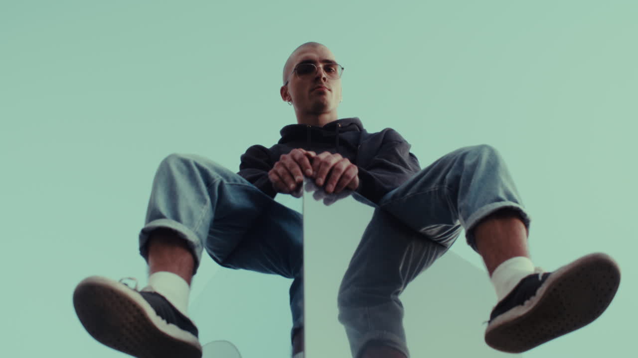 Stylish Man Sitting on a Wall