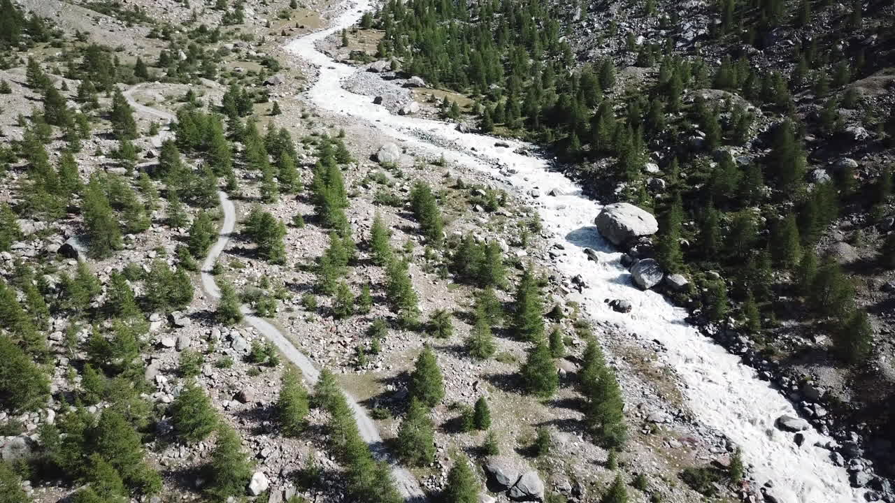 Swiss alps mountain valley, fir forest and mountain stream, drone aerial view