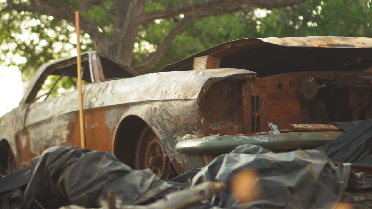 Frontal close up view of an isolated rusty corroded muscle car
