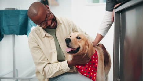 man hugging his dog at the vet