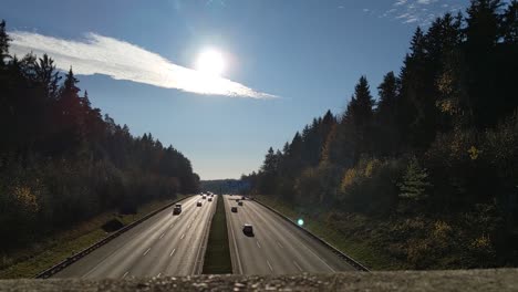 view from a bridge down to the german autobahn with many cars passing