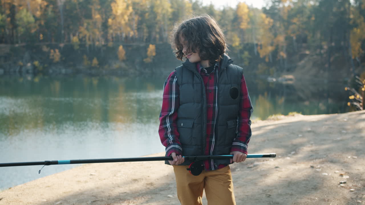 Young Boy Fishing in Autumnal Quarry
