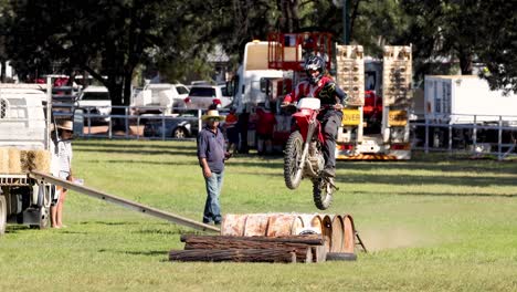 motorcyclist competes in log pulling event