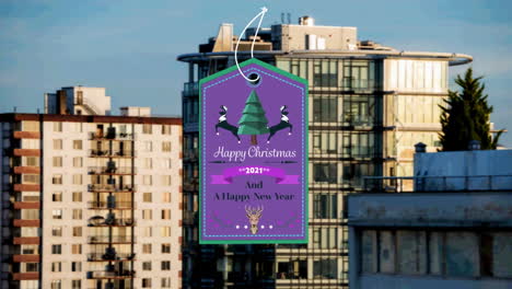 animation of christmas greetings on tag over cityscape in background
