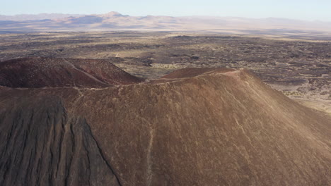 rotating aerial view of the lip of the volcanic amboy crater in the mojave desert