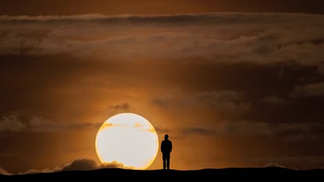 the silhouette of man on the bright sun background. time lapse