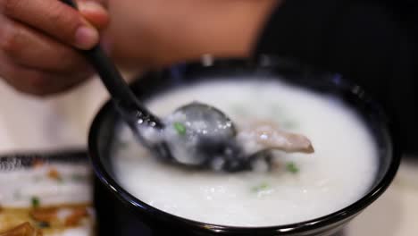 savoring a bowl of rice porridge