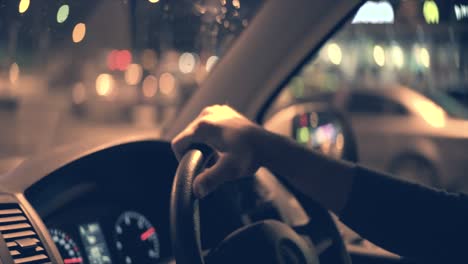 el hombre conduciendo un coche en la ciudad nocturna
