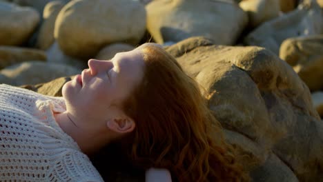 Woman-relaxing-on-the-beach-at-dusk-4k