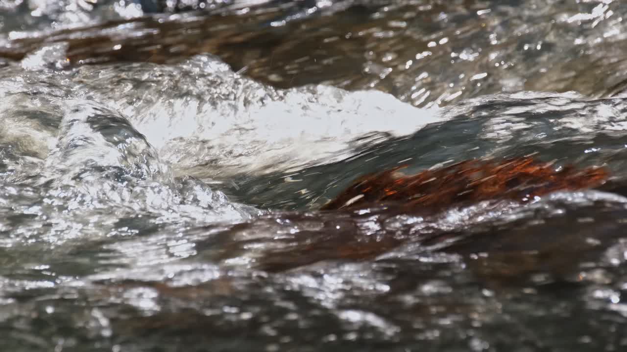 River flowing through rocks creating whitewater during a hot afternoon in the jungle in Khao Yai National Park, Thailand