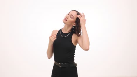 portrait of a confident woman in a black outfit with curly hair
