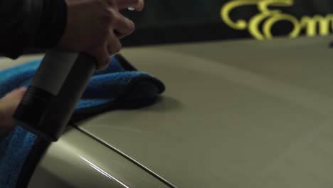 quick clean with shampoo on bonnet of a bmw golden sedan car