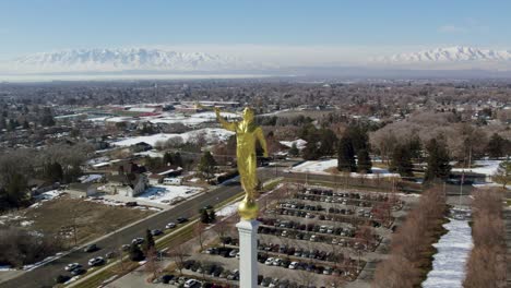 gold, moroni statue on mount timpanogos mormon temple, church of jesus christ of latter-day saints, aerial drone orbit