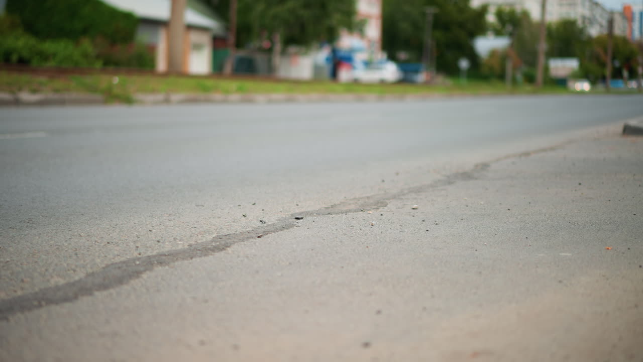 Van Wheel Over Cracked Pavement In Suburban Street, Closeup Frames Show Tire Tread, Dust And Rut Line, Commercial Delivery Context With Motion Blur And Road Wear, Visual Focus On Surface Damage