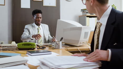 employees sitting in vintage office.