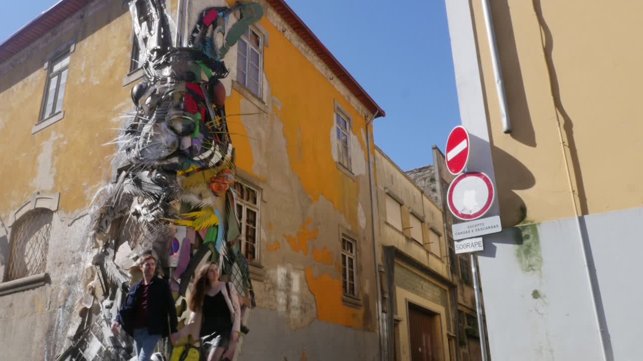 Wide shot of cute couple holding hands walking past impressive art