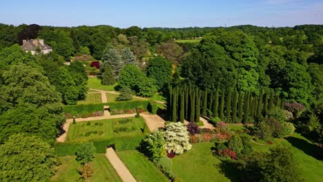 upside drone view of the elegant terraced and beautiful upper brittany botanical park nestled within tall trees, le chatellier, france.