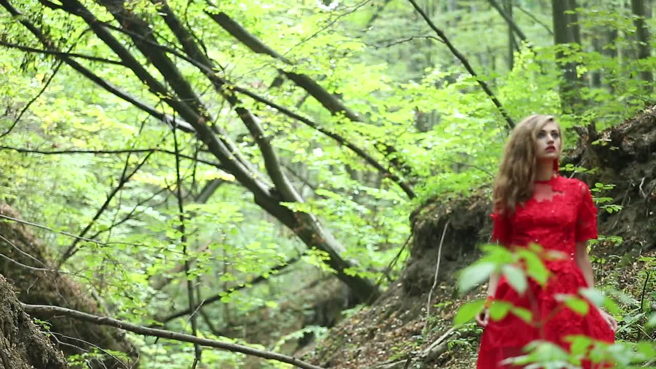 Girl Lost In Forest. Girl in long red dress lost in forest