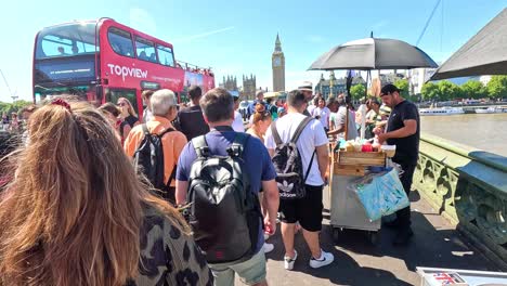 crowd explores westminster with sightseeing buses