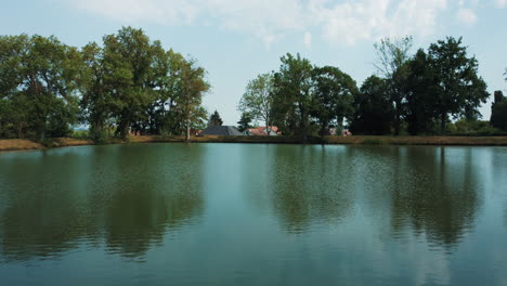 serene pond with surrounding trees and houses