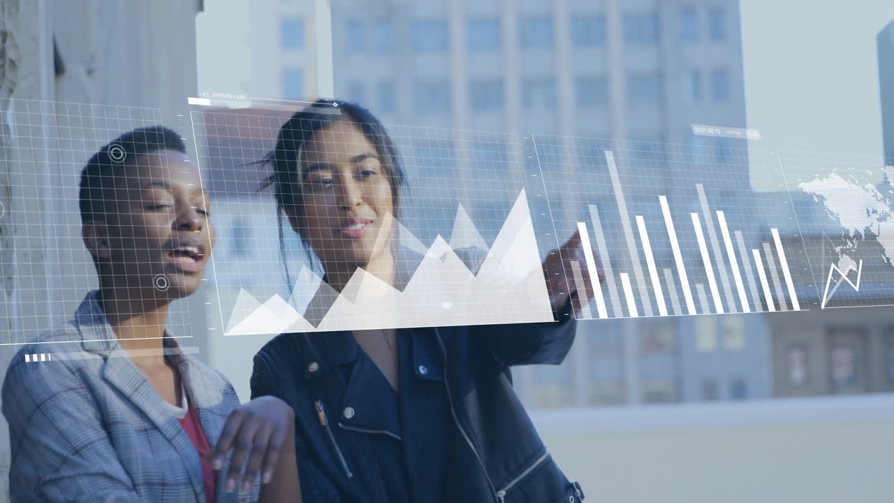 two businesswomen standing by glass window examining floating grid line chart bar chart world map