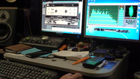Sound engineer working at mixing panel in boutique recording studio. Close-up