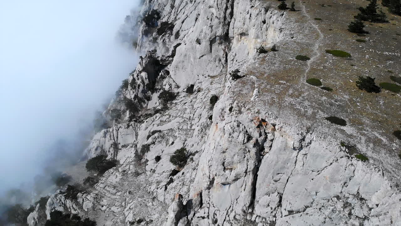 Aerial View of a Rocky Mountain Cliff with Fog